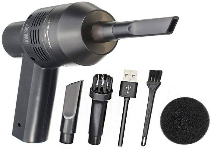 a black handheld vacuum with its attachments and charger laid out next to it on a white background