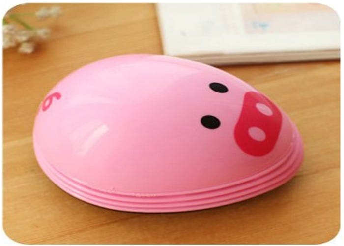 a small oval-shaped keyboard vacuum designed to look like a pig