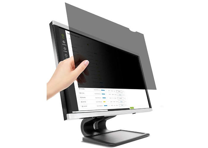 person placing a black privacy screen over a computer monitor