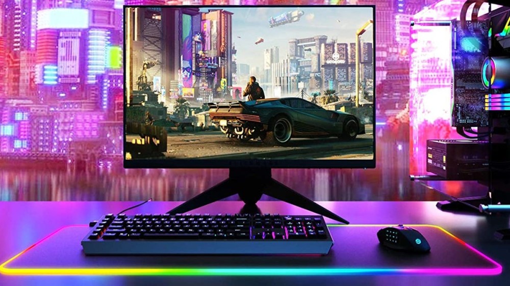 A gaming setup with a large RGB mouse pad, a monitor, and a keyboard.