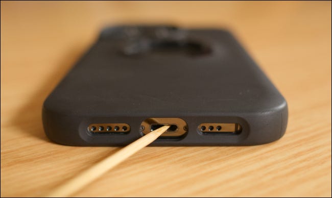 Cleaning an iPhone's Lightning port with a toothpick