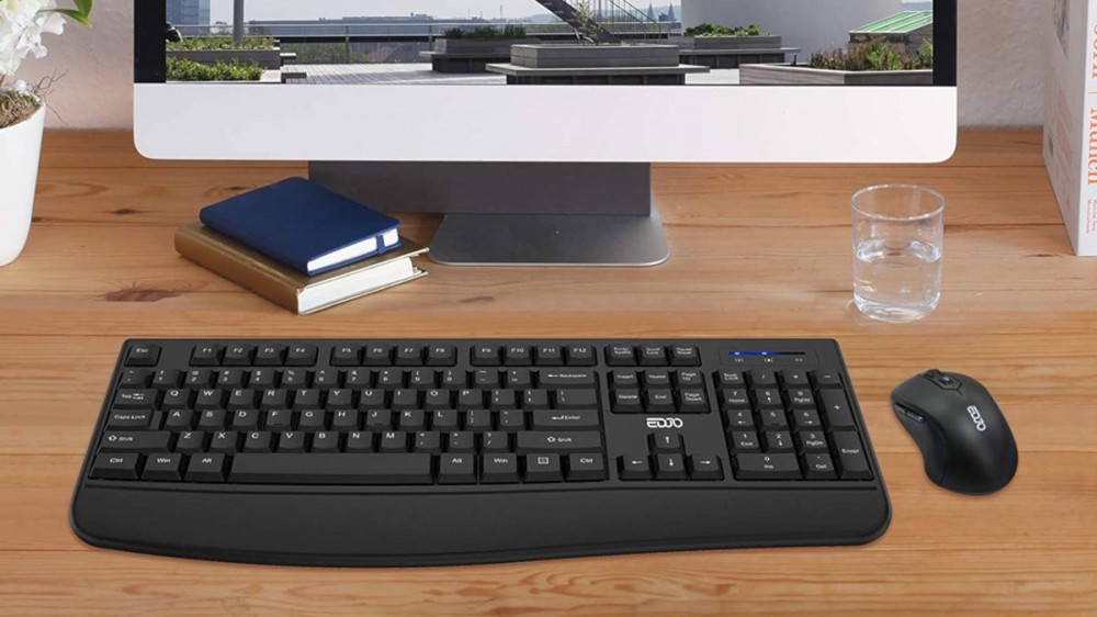 Black EDJO wireless keyboard and mouse positioned in front of a computer monitor