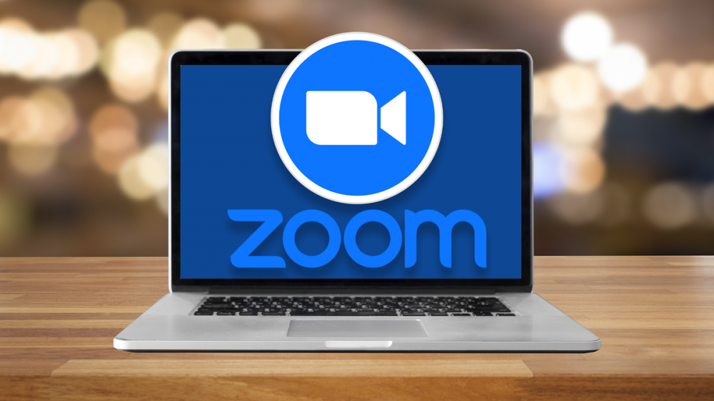 The Zoom logo over a MacBook