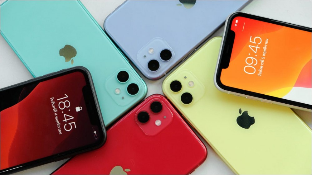 Several Apple iPhone 11 models in varying colors arranged in a circle.