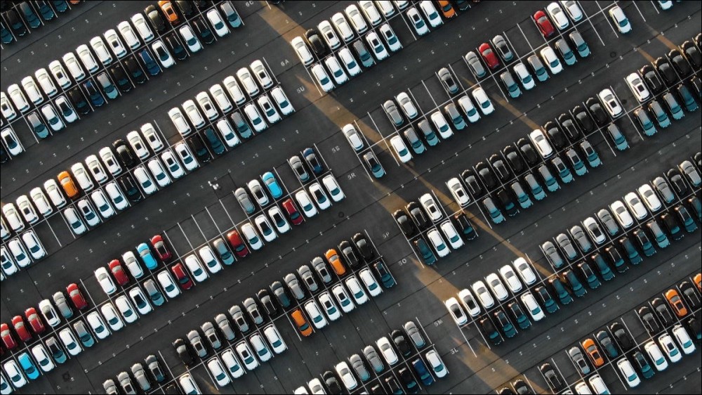 An aerial view of hundreds of vehicles parked in a parking lot