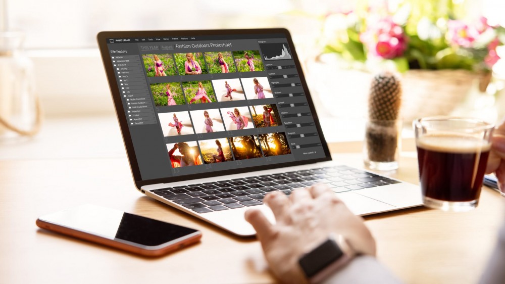 Woman editing digital photos on laptop computer.