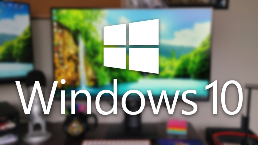 The Windows 10 logo over a PC running the Windows 10 desktop OS.