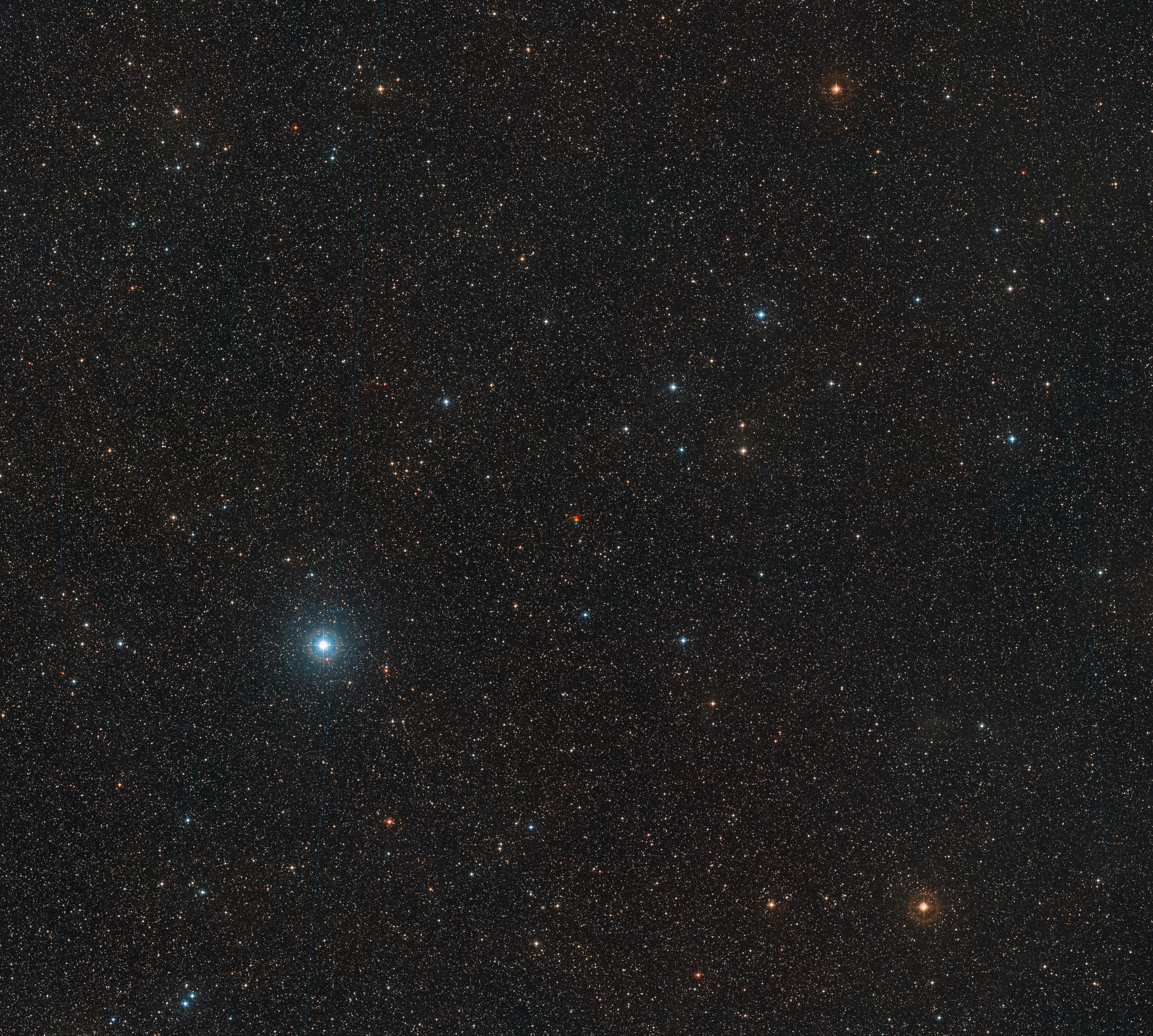 This wide-field image shows the surroundings of the red dwarf known as Barnard’s Star in the constellation of Ophiuchus (the Serpent-Bearer). This picture was created from material forming part of the Digitized Sky Survey 2. The centre of the image shows Barnard’s Star captured in three different exposures. The star is the fastest moving star in the night sky and its large apparent motion can be seen as its position changes between successive observations — shown in red, yellow and blue.