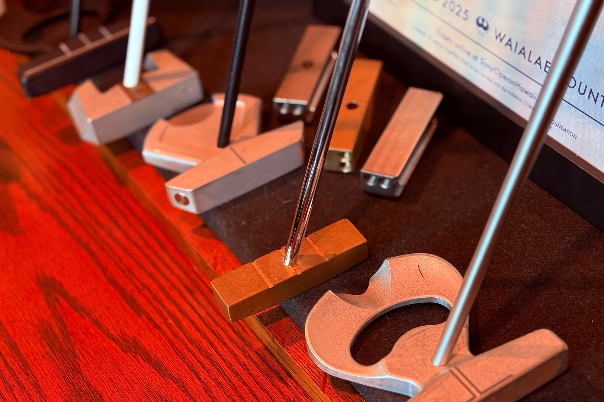 Raw metal prototypes of multiple LAB Golf putter models on the shelf of CEO Sam Hahn