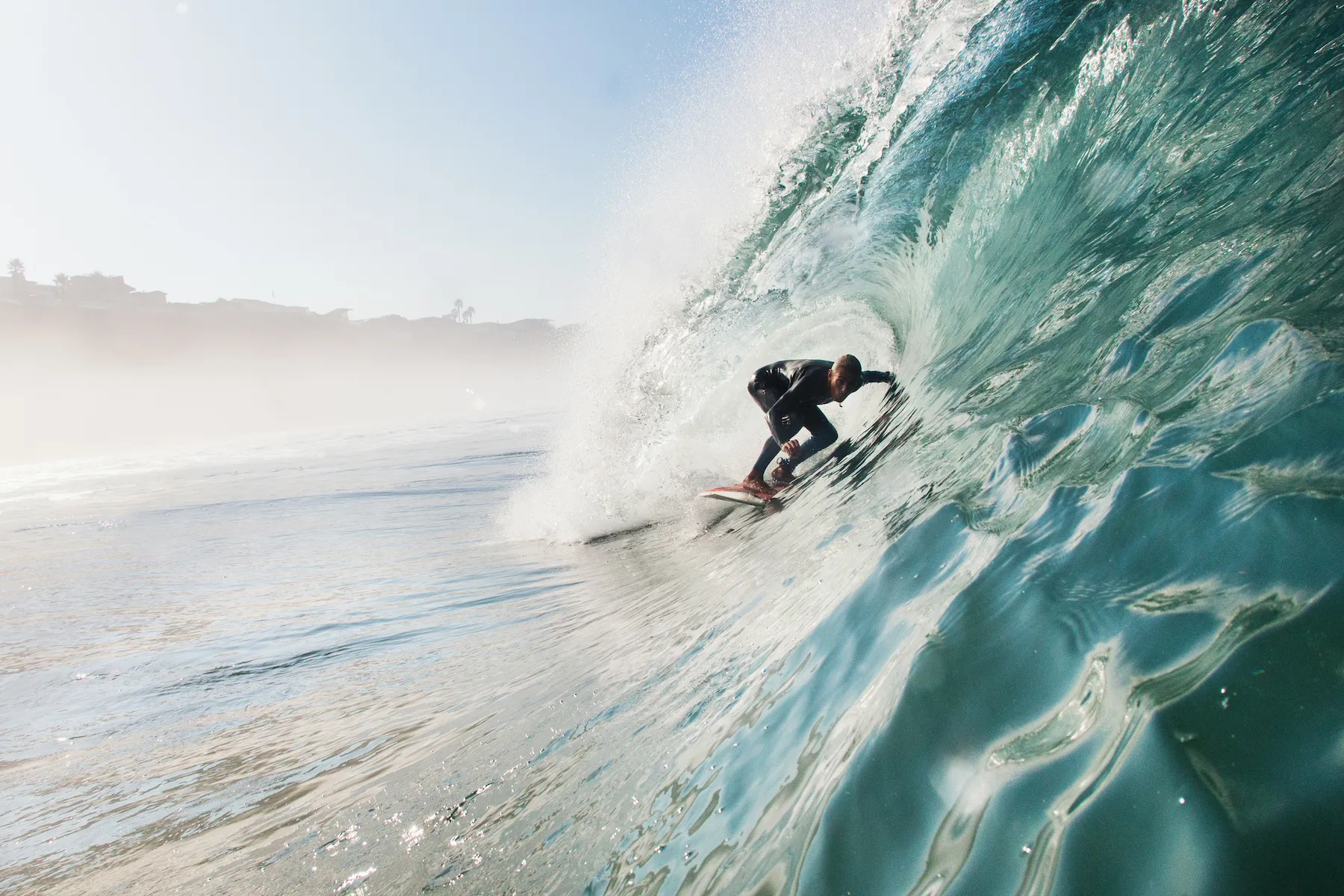 a surfer inside the barrel of a wave
