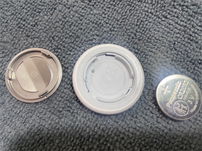 Airtag with back cover and battery removed