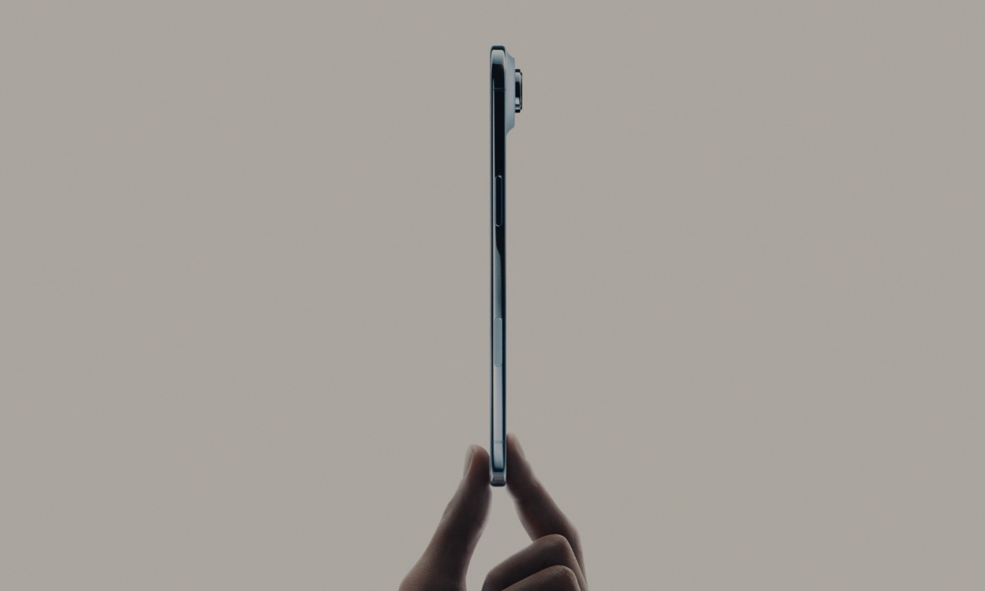 Side-profile of iPhone Air being held with two fingers.